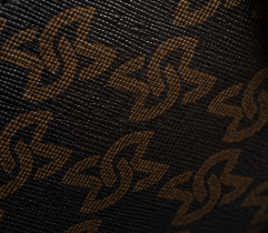 Real Bismarck outer material showing the surface texture and bronze monogram